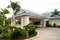 View of the entrance group of a white hotel on the Caribbean coast in the Dominican Republic. Palm trees around the