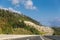 View of entrance of tunnel in mountains of Croatia. Beautiful landscape with mountain and forest, highway with red car