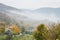 View of the Euganean Hills in autumn with fog and yellow vineyards - near Este, Padua