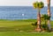 View on evergreen grass field on large golf course and blue Atlantic ocean on Tenerife island, Canary, Spain