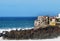 View of the exfoliated outer walls of the colorful dice houses of a fishing village on Tenerife, built on lava rocks