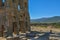 View at the exterior front facade of medieval Saint CornÃ©lio tower, woman looking the building, iconic ruins monument building at