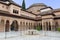 View at the exterior at the Patio at the Lions, twelve marble lions fountain on Palace of the Lions or Harem, Alhambra citadel,