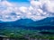 View of extinct volcanoes with village near foothills.