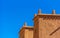 View of the facade of a building in Ait-Ben-Haddou, Morocco. Isolated on blue background