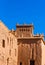 View of the facade of a building in Ait-Ben-Haddou, Morocco. Vertical. Isolated on blue background