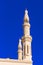 View of the facade of the building of the mosque Jumeirah. Isolated on blue background, Dubai, United Arab Emirates. Vertical