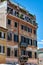 A view of facade of generic picturesque roman building with aged walls on the streets of Rome, Italy