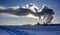 View of factory power plant in winter with steam rising into deep blue sky, sun shines behind steam, sea port with the boat at