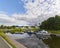 A view of the Falkirk Wheel and Visitors Complex taken from the Forth and Clyde Canal, with its moored Canal Boats.