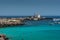 View of the famous Cala Azzurra beach and the Punta Marsala lighthouse in Favignana