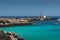 View of the famous Cala Azzurra beach and the Punta Marsala lighthouse in Favignana