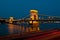 View of the famous chain bridge in Budapest at night.