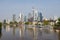 View of the famous Frankfurt Skyline and the banking district with the river Main at the foreground and against a blue sky