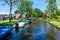 View of famous Giethoorn village with canals and rustic thatched roof houses.