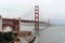 View of the famous Golden Gate Bridge in San Francisco, California partially covered with mist