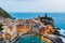 View of famous travel landmark destination Vernazza, small mediterranean old sea town with harbour coast and castle