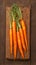 view Farm fresh baby carrots on a wooden cutting board, ready to enjoy