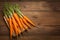 view Farm fresh baby carrots on a wooden cutting board, ready to enjoy