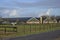 View at farm with horse, barns and silo