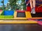 View of the feet of a boy in striped socks jumping on trampoline practicing acrobatics