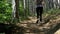 View on feet of traveler woman hiking on the forest trail path in mountain