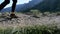 View on Feet of Traveler Woman Hiking Walking on the Top of Cliff in Mountain. Slow Motion