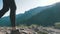 View on Feet of Traveler Woman Hiking Walking on the Top of Cliff in Mountain. Walking on Rocks