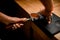 view of female baristas hand tamping coffee in portafilter before making fresh drink