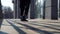 View of female legs in black boots dancing on street tiles in rays of sunset