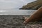 View of female\'s legs on the sand of Caves of Matala, Greece