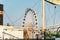 View of the ferris wheel through the ship on the embankment of the Motlawa river in the city of Gdansk, Poland. Ferris wheel in