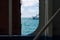 View of ferry, sea and sky through metal ferry door