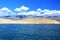 View from ferry to rocky part of Island Rab and Velebit mountain in background