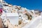 View of Fira town - Santorini island,Crete,Greece. White concrete staircases leading down to beautiful bay