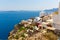 View of Fira town - Santorini island, Crete, Greece. White concrete staircases leading down to beautiful bay