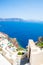 View of Fira town - Santorini island,Crete,Greece. White concrete staircases leading down to beautiful bay with clear blue sky and