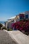 View of Fira town - Santorini island,Crete,Greece. White concrete staircases leading down to beautiful bay with clear blue sky and