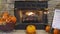 View of a Fireplace With a Fire, all Decorated for Autumn With Pumpkins, Scarecrows and Fall Leaves.