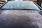 View of a first layer of snow on a car in the morning in wintertime in Bucharest, Romania