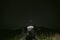 View from the first person. Motorcycle steering wheel. On a tourist motorbike in the middle of a mountain dirt road. The night is