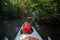 View from the first person. A trip on a SAP board. A narrow river in the middle of the forest, an extreme route. bag with water