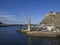 View on fisherman boats dock harbor in San Marcos village on Tenerife with ship crane, sea, hill