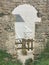 View of fishermen huts through an old medieval stone gate