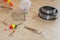 View of fishing accessories on white wooden table. Items include fishing reel, hooks, floats