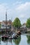 View on fishing harbor and old Dutch houses and tower in Zierikzee, historical town in Zeeland, Netherlands