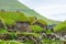 View of fishing village in Koltur island. Faroe Islands. Green roof houses. Nordic natural landscape