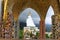 View of five white sitting Buddhas framed through the mosaic pillars at Pha Sorn Kaew, Khao Kor, Phetchabun, Thailand.