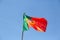 View of a flag of Portugal on a flagpole waving in the wind