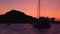 View from floating sailing yacht on anchored sailboats in Mediterranean sea, Lipari Islands. Sunset, colorful sky
